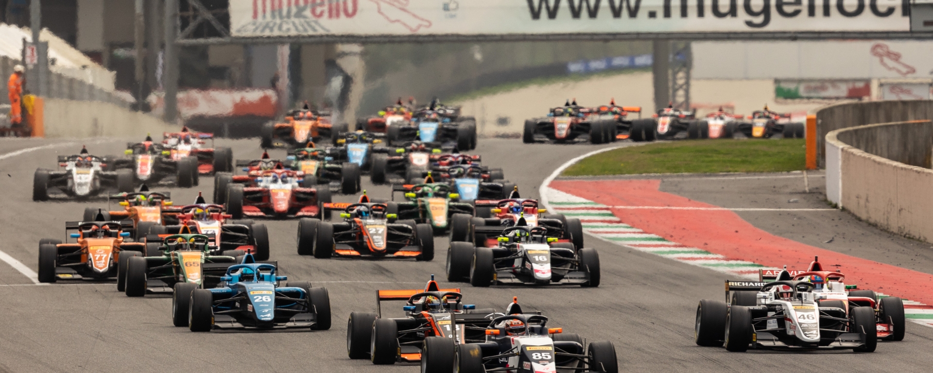 Front view of 34 FRECA cars racing down the start-finish straight at Mugello