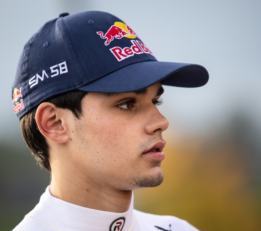 Sebastián Montoya, wearing a Red Bull cap, looks to the right