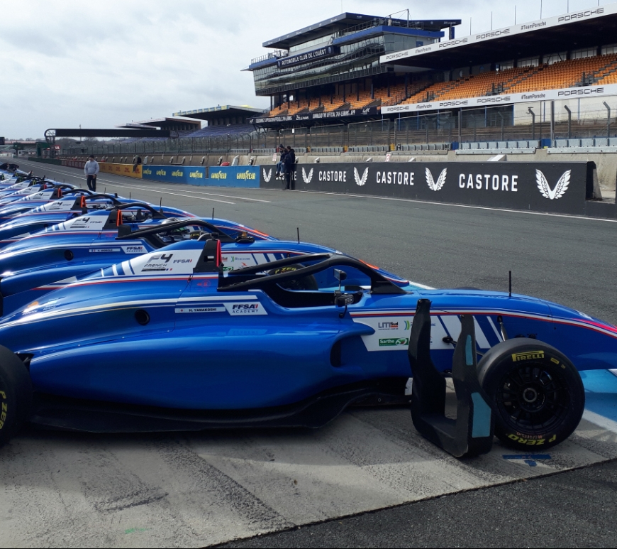 French F4 cars lined up on pit lane at Le Mans, facing to the right