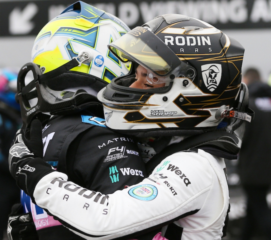 Aiden Neate (left) and Louis Sharp (right) hug in parc fermé while in race kit